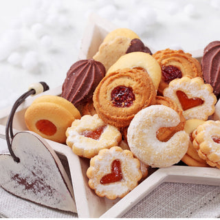 Assorted German Christmas cookies with jam fillings in a star-shaped bowl