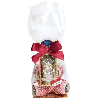 Gift package with cookies, red ribbon, and a label on a white background