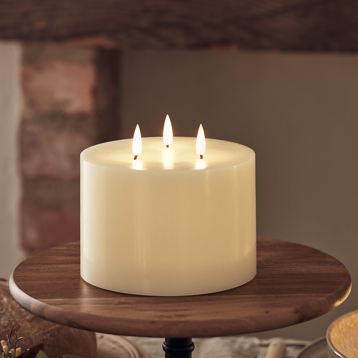 Gemütliche Sitzecke mit LED-Kerzen und Lichterketten an Sessel und Hocker