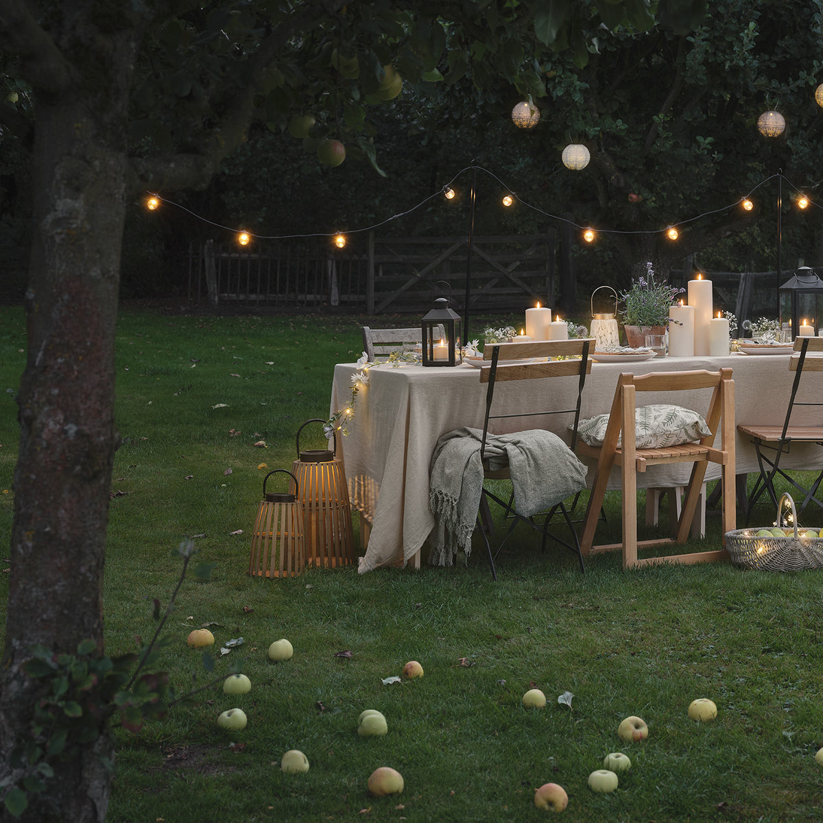 Gartenparty mit Bambus-Solarlaternen, Kerzen und Lichterketten am Abend