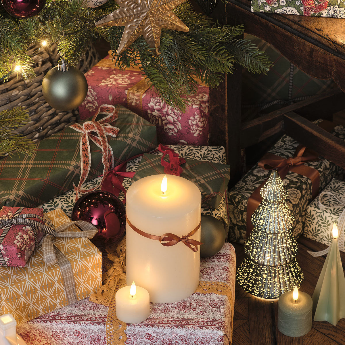 Weiße und grüne LED-Kerzen mit Weihnachtsgeschenken und Deko unter Tannenbaum