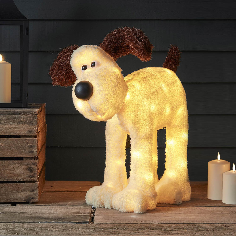 Leuchtende Gromit LED-Figur mit braunen Ohren und schwarzer Nase vor dunklem Hintergrund