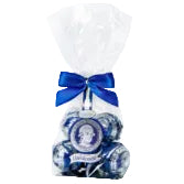 Bouquet of blue and white flowers in a clear cellophane bag with a blue ribbon.