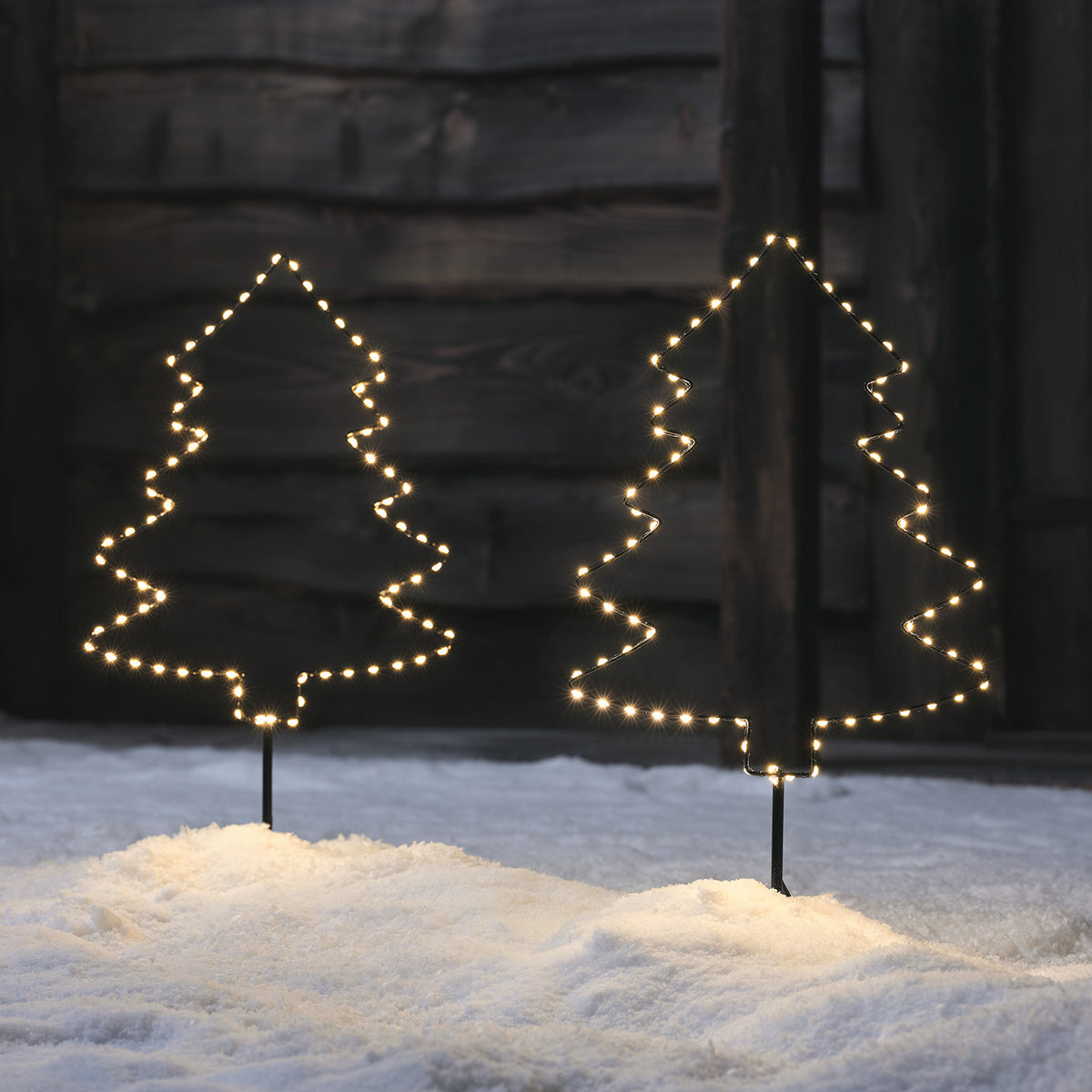 Zwei Micro LED Stableuchten in Form von Weihnachtsbäumen mit warmweißen Lichtern im Schnee