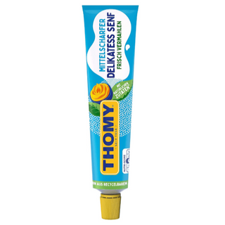 A tube of Thomy medium hot mustard. The packaging is predominantly yellow and blue, with the Thomy logo prominently displayed.