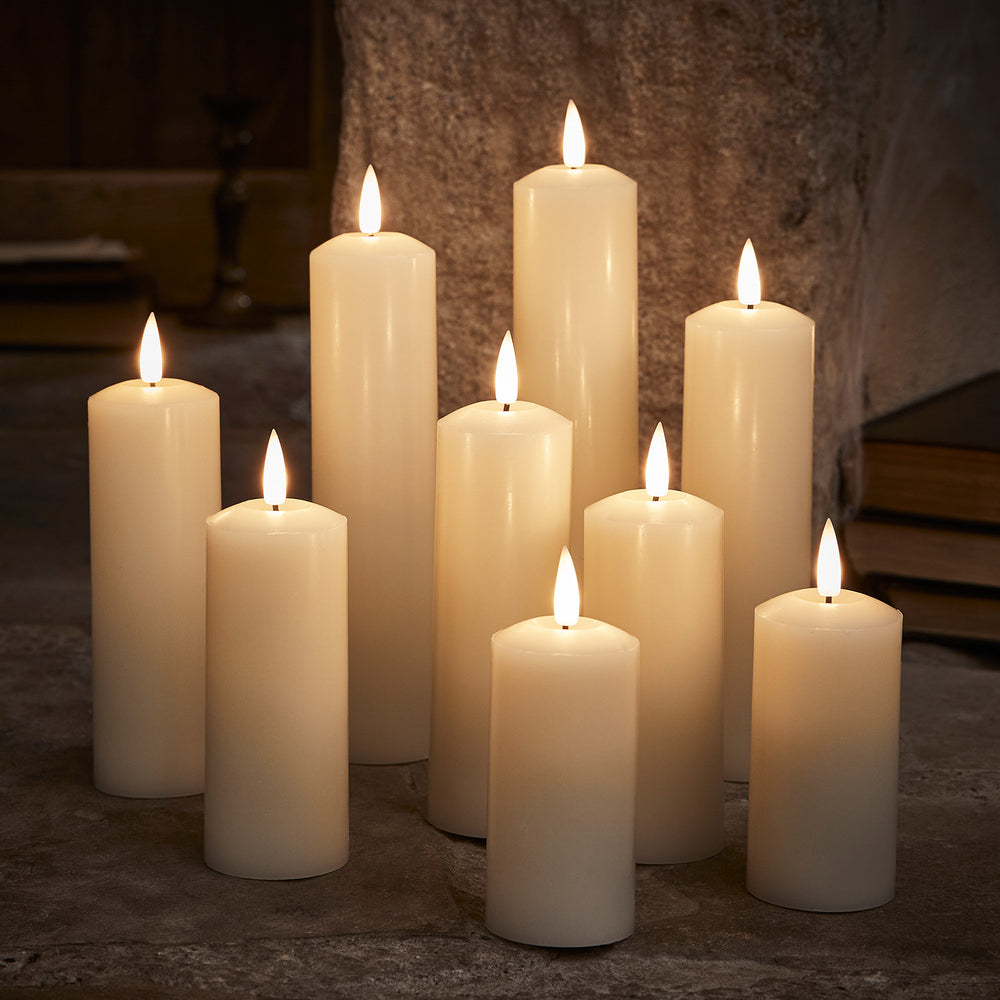 Neun weiße LED Echtwachskerzen in verschiedenen Höhen mit warmem Flammeneffekt