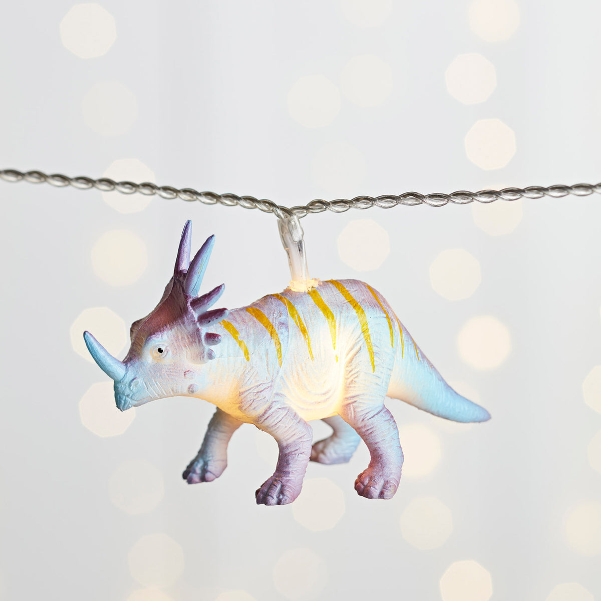 Leuchtender blauer und lila Dinosaurier Anhänger an Lichterkette